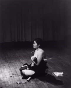 Yoko Ono performing Cut Piece at Carnegie Recital Hall, New York, 1965